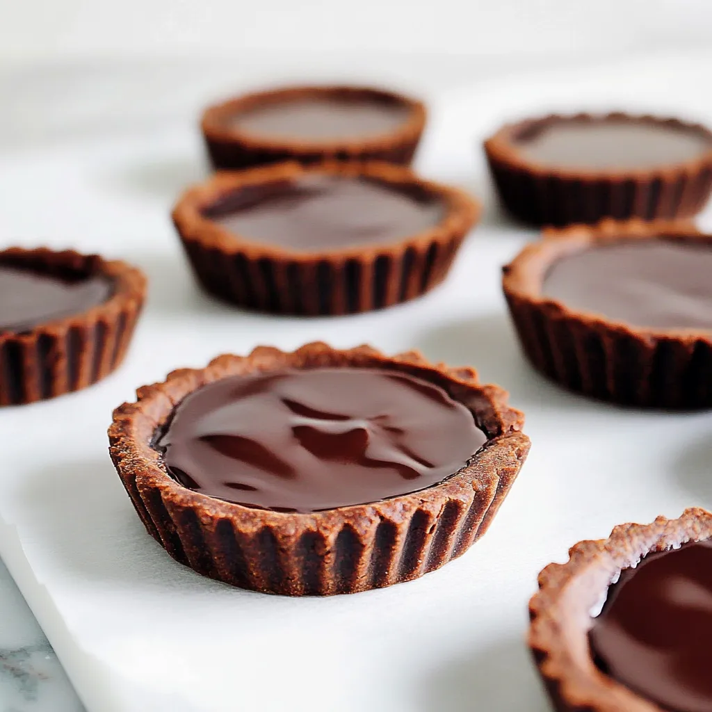 Chocolate cupcakes on a white plate.