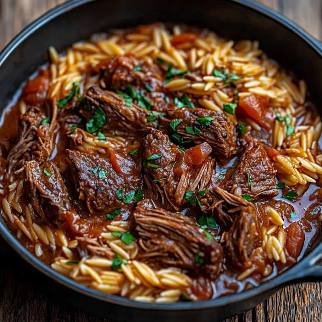 A black skillet with a delicious meal of beef and rice.