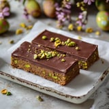 A piece of chocolate cake with almonds on top.