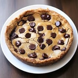 A chocolate chip cookie on a plate.