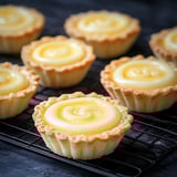 A tray of small pastries with a yellow filling.